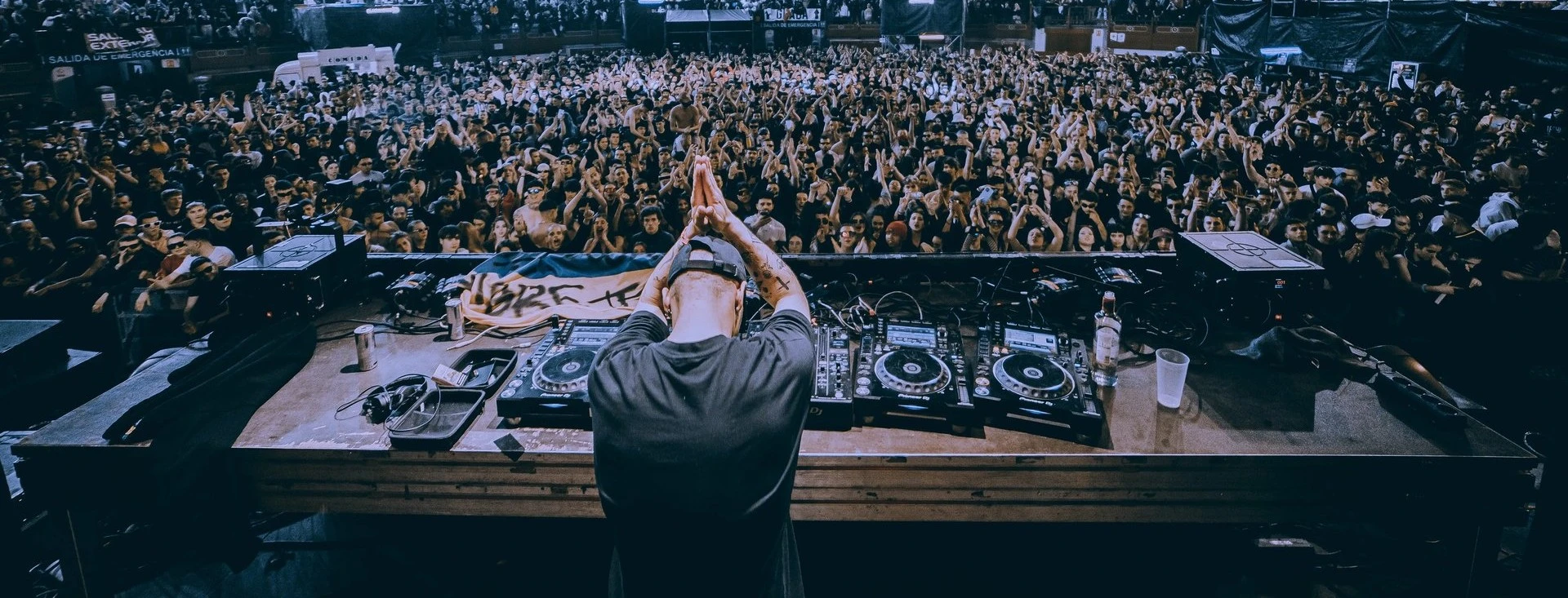 Nico Moreno performing live at a crowded techno rave