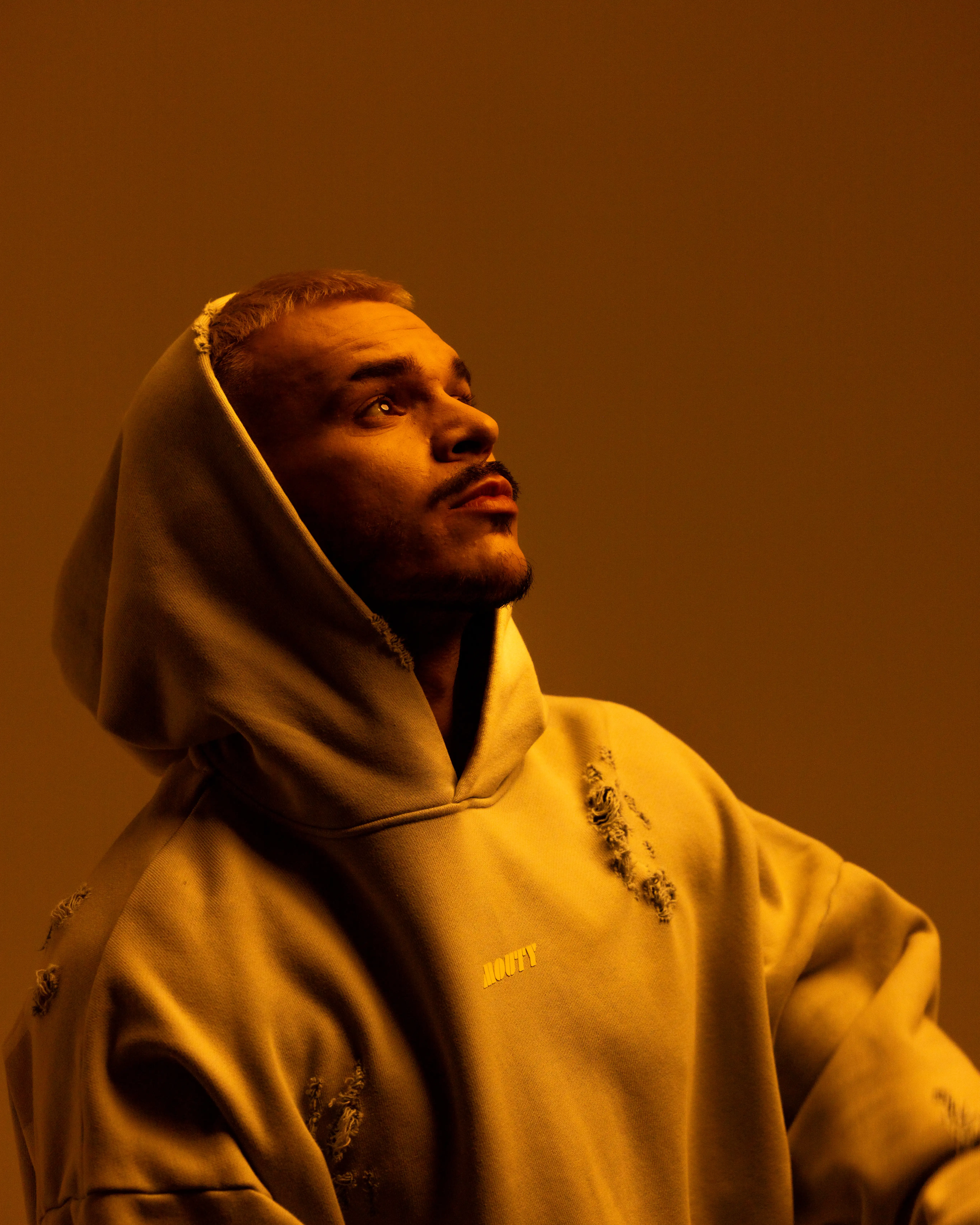 Nico Moreno behind the DJ booth with red lights